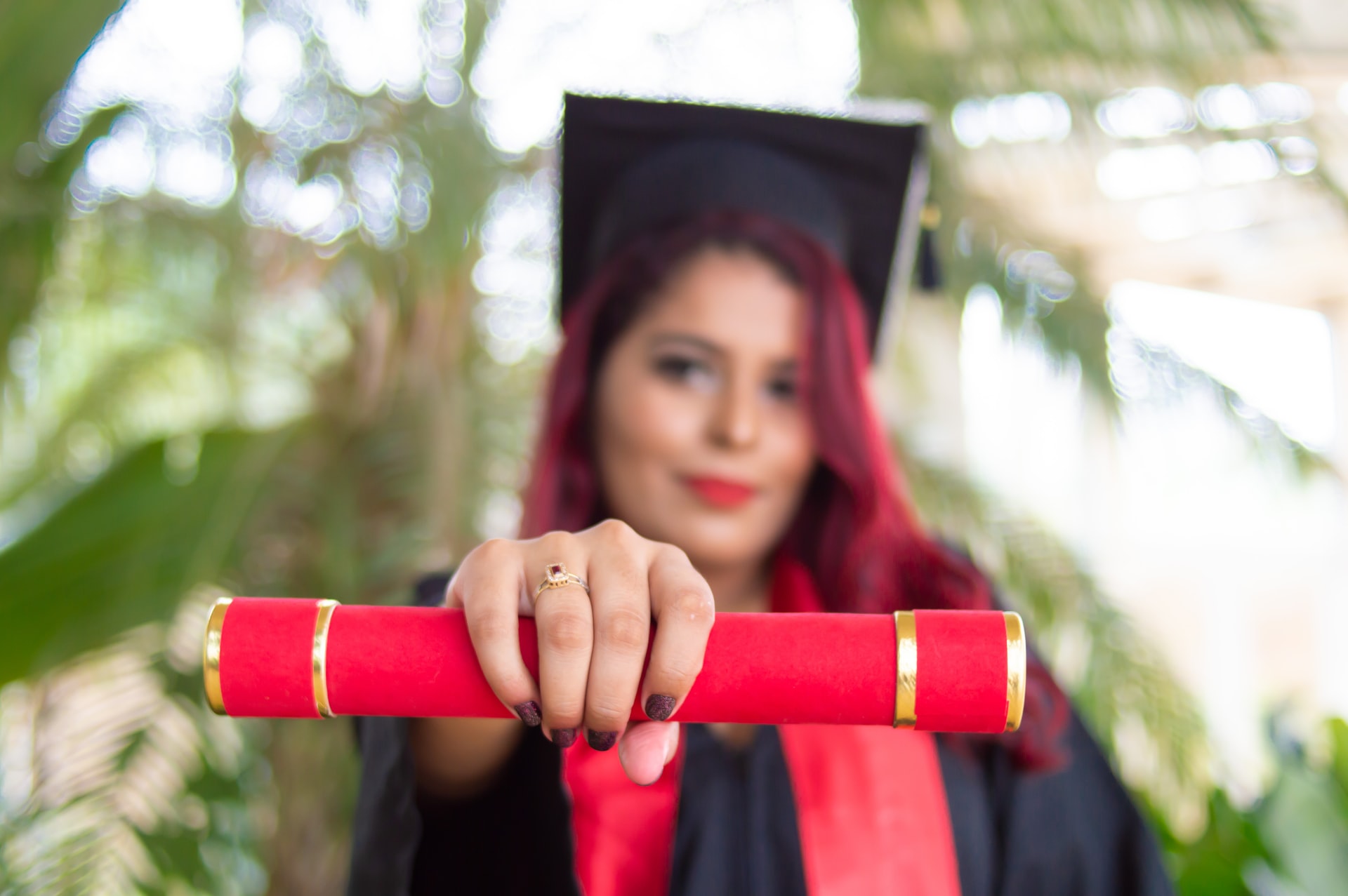 A female graduate holding the certificate